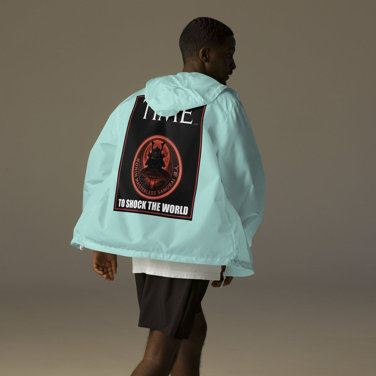 Ronin Cover Story Windbreaker, aqua white zipper back: back print of a red-framed cover-style poster with the round RONIN samurai seal and TO SHOCK THE WORLD