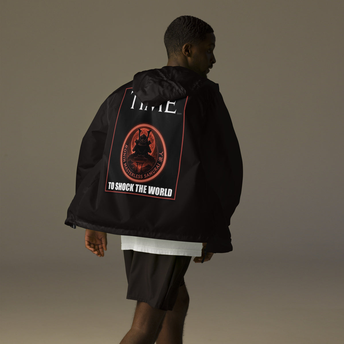 Ronin Cover Story Windbreaker, black back: back print of a red-framed cover-style poster with the round RONIN samurai seal and TO SHOCK THE WORLD