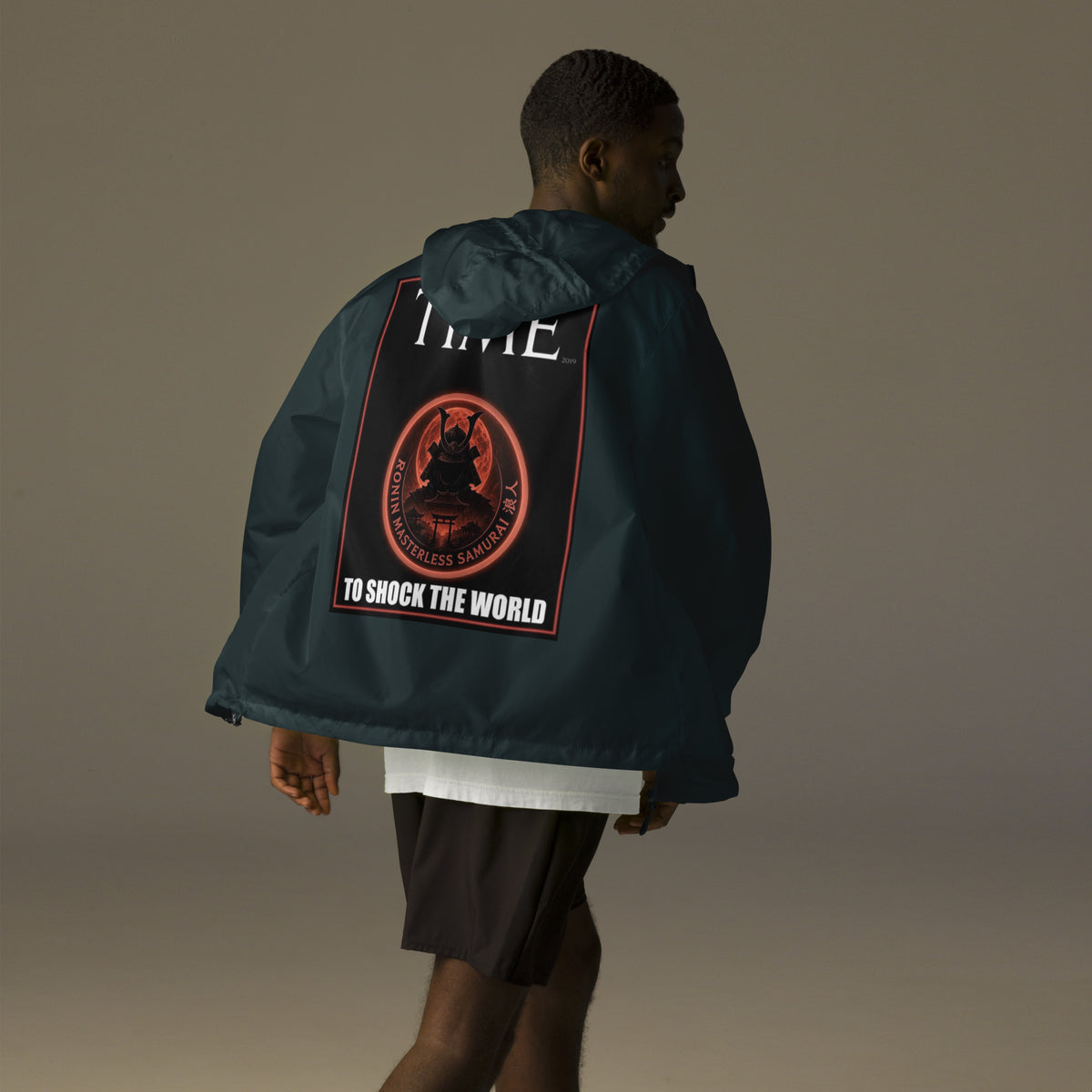 Ronin Cover Story Windbreaker, classic navy back: back print of a red-framed cover-style poster with the round RONIN samurai seal and TO SHOCK THE WORLD
