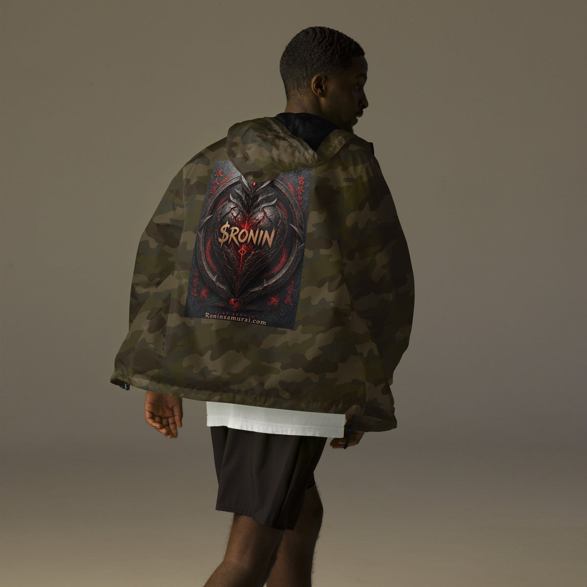 Obsidian Heart Ronin Windbreaker, forest camo back: spiked black armored heart with a glowing red core and $RONIN, red kanji at the sides