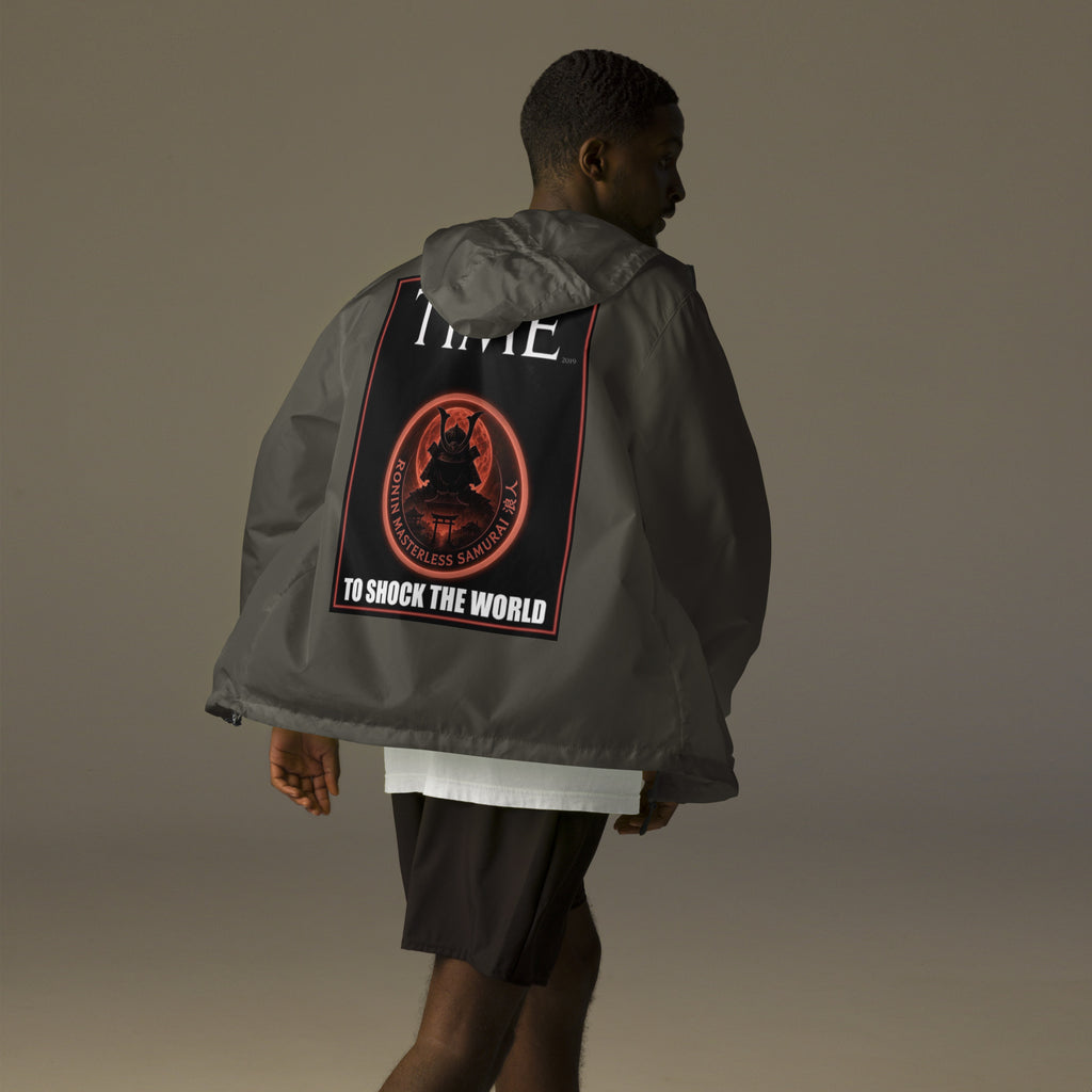 Ronin Cover Story Windbreaker, graphite back: back print of a red-framed cover-style poster with the round RONIN samurai seal and TO SHOCK THE WORLD