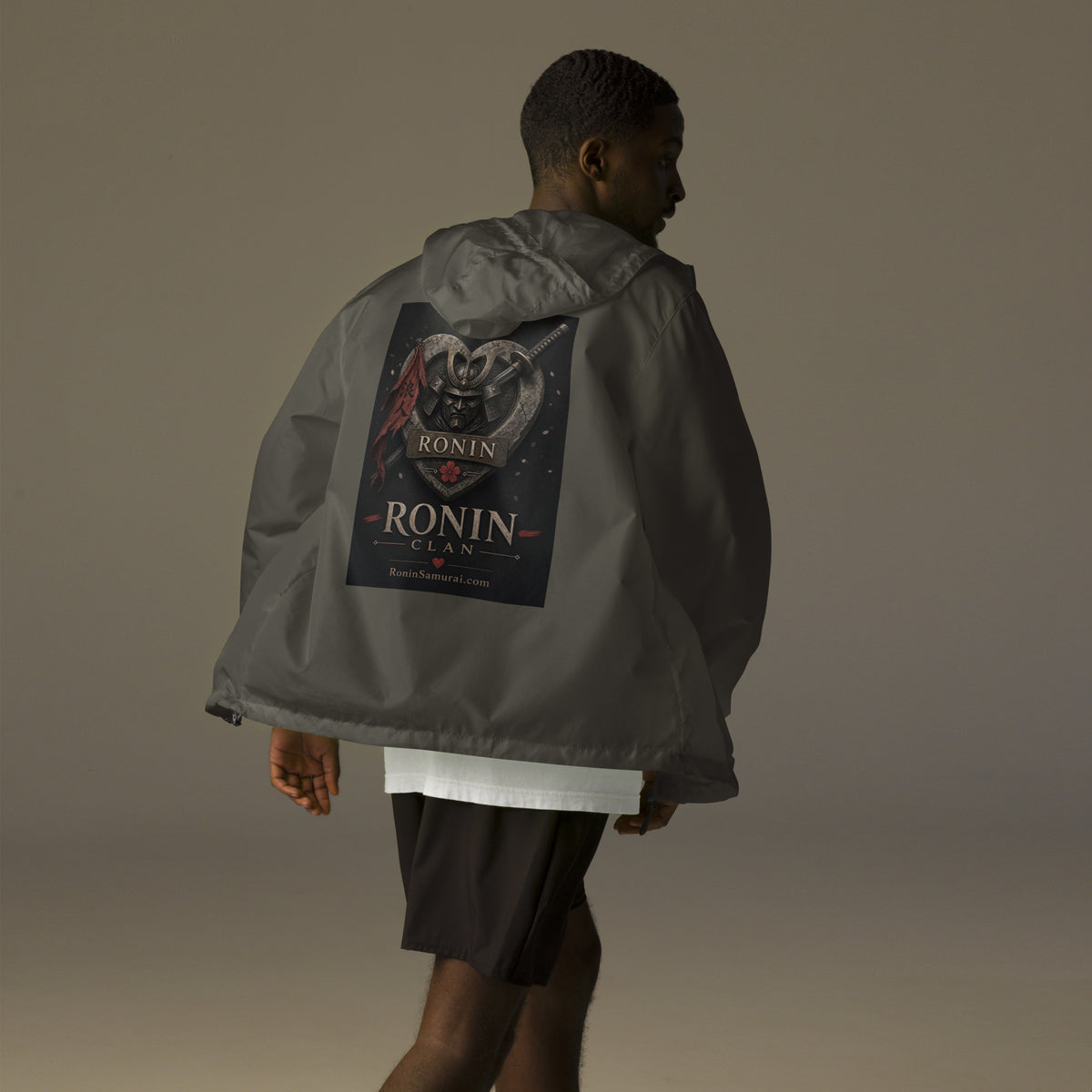 Kabuto Heart Ronin Clan Windbreaker, graphite back: stone heart with a masked kabuto warrior, katana and red banner, RONIN CLAN